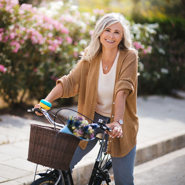 smiling middle aged woman riding bicycle