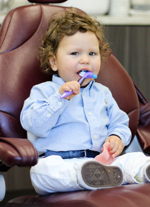 Dr. Yevgeniy's son Jordan brushing his teeth at the clinic.