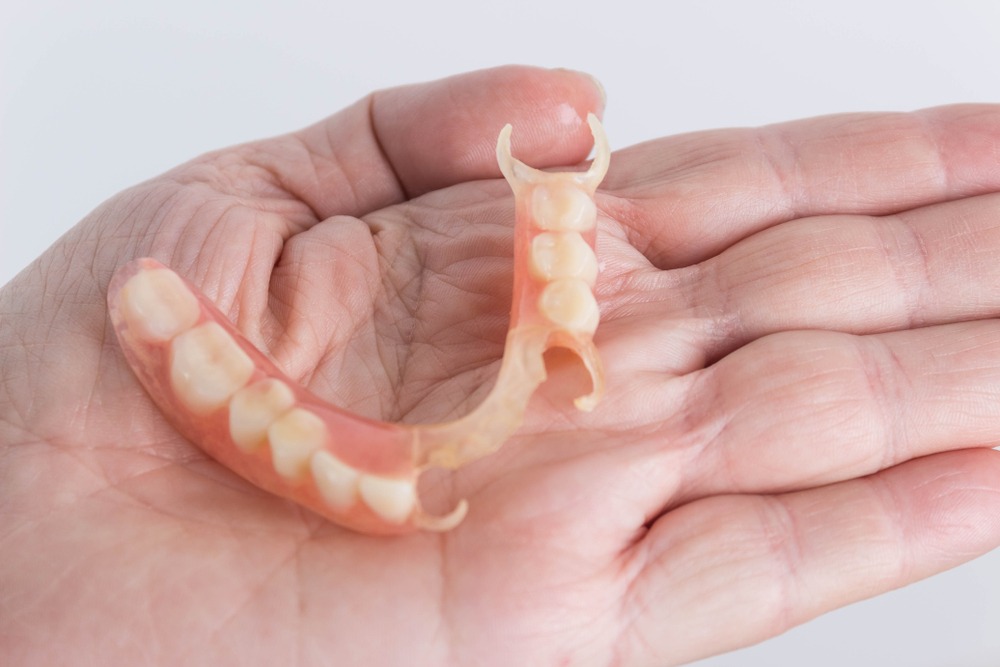 dentures shown in hand