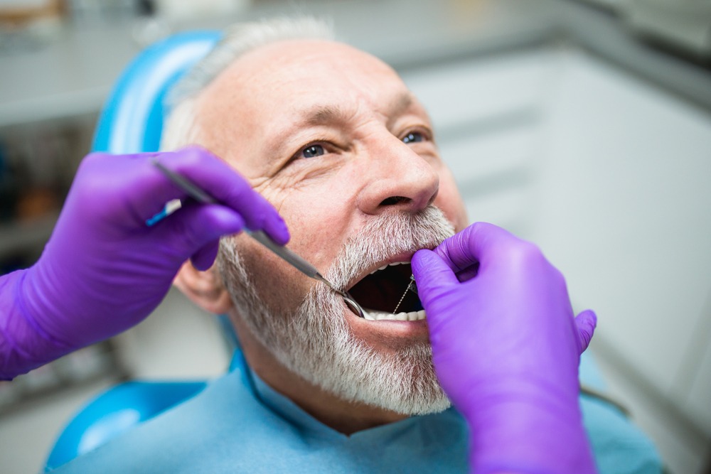 man gets oral hygiene checkup