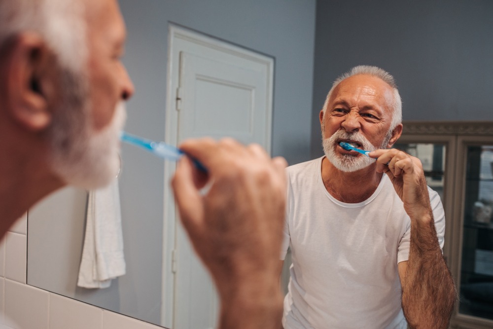 man brushing teeth for oral health