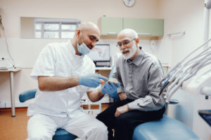 denturist and dental patient in denture clinic