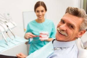 man smiling at denture clinic with denturist