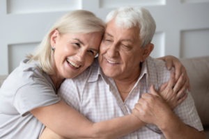 elderly couple with bright white smiles