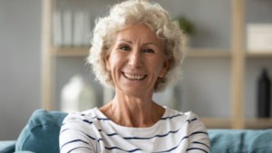 elderly woman smiling directly at camera