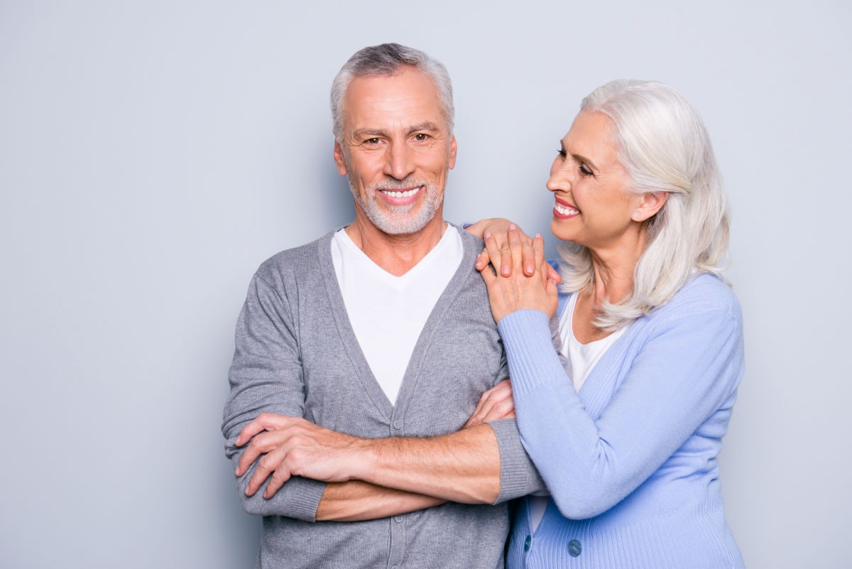 elderly couple with bright white smiles