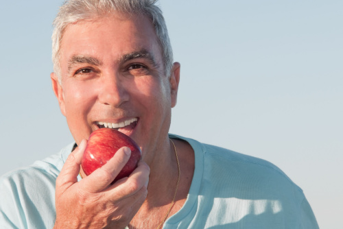 A man eating with his dentures