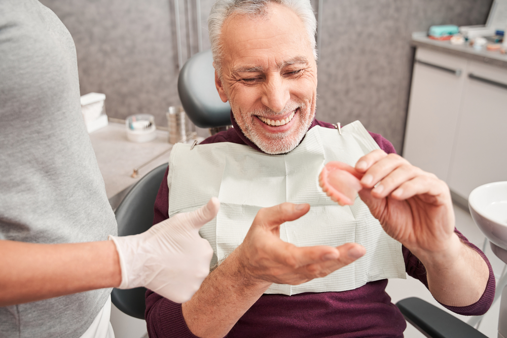 denture patient handles teeth