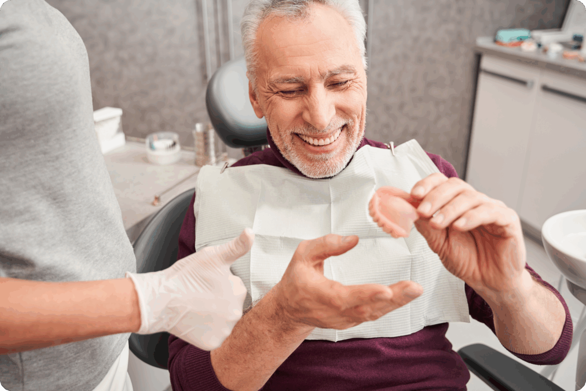 Man looking at dentures
